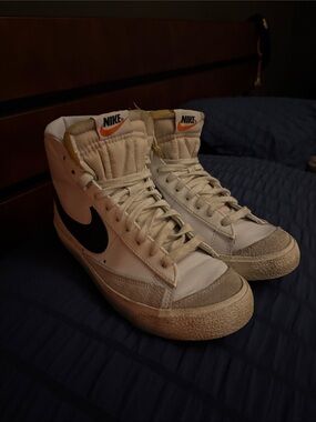 Nike Women’s High-Top Sneakers in White with Black Swoosh and Orange Tongue Logo
